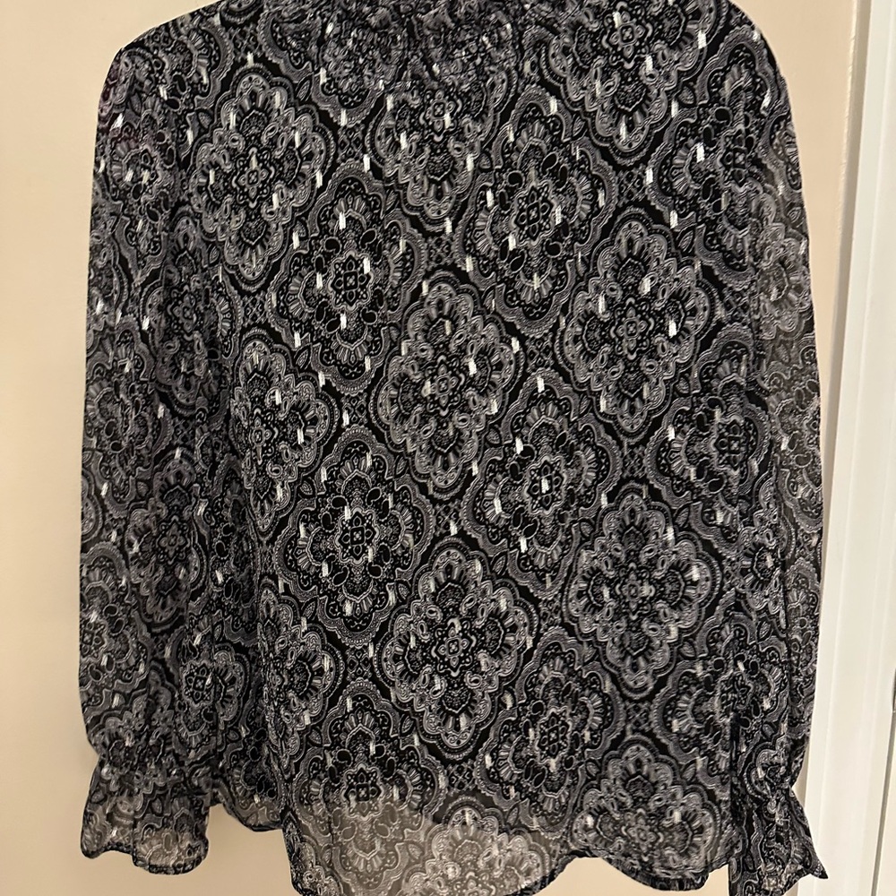 Elegant Black and White Women's Top with silver accents.